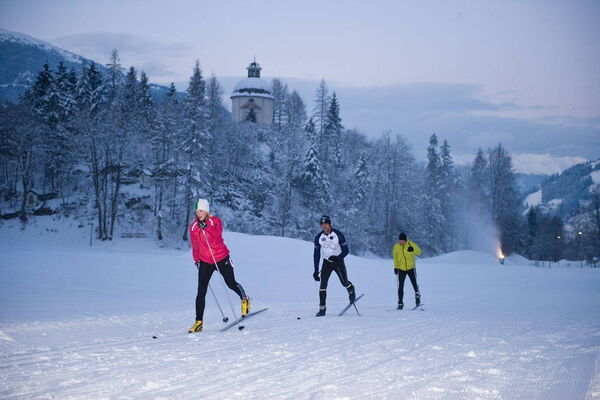 Cross-country skiers on a trail in the snow-covered Zillertal valley