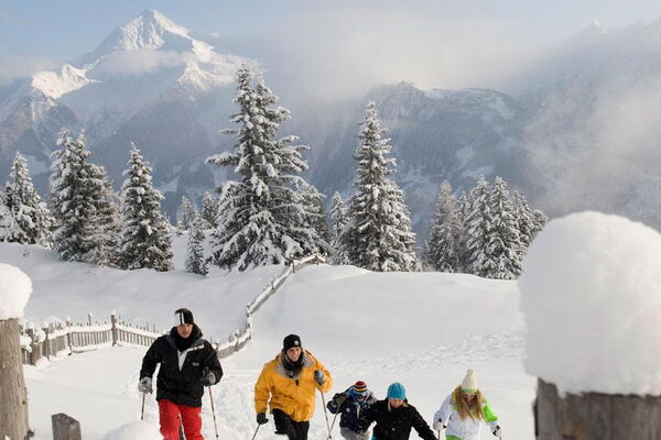 Winter hikers on a snow-covered trail in the Zillertal valley